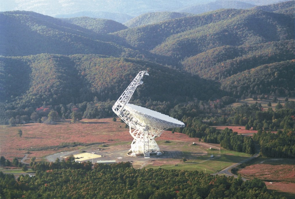 The Robert C. Byrd Green Bank Radio Telescope (GBT) has a collecting area of 2.3 acres (0.93 ha) which focuses the radio waves falling on it onto sensitive receivers at the top of the boom attached to the side.